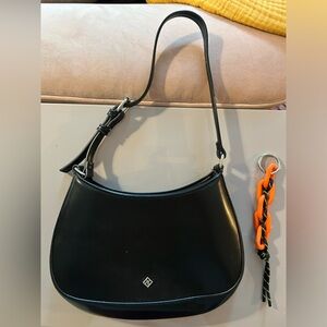 Black shoulder bag with bag charm